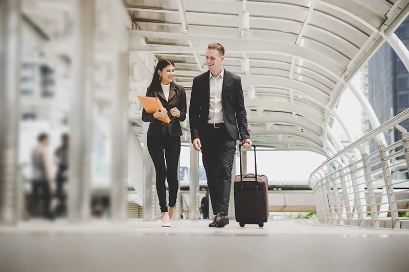 Two business travellers walking along a corridor